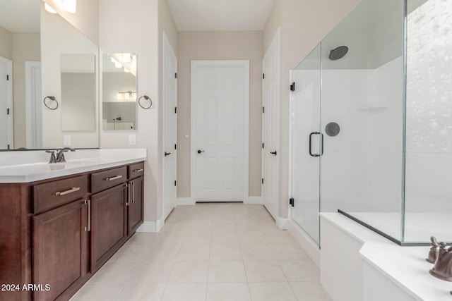 bathroom with tile patterned flooring, vanity, and a shower with shower door