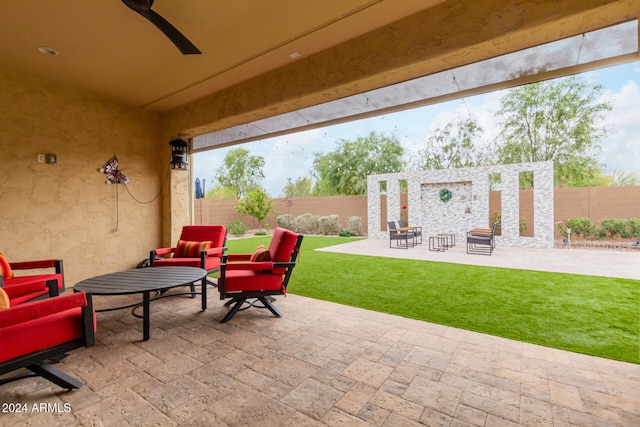 view of patio with an outdoor living space and ceiling fan