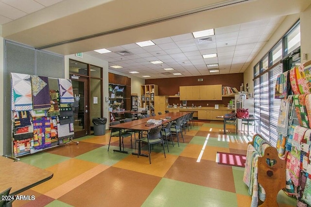 game room with a drop ceiling