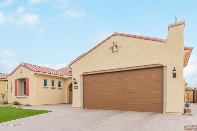 mediterranean / spanish-style house with a garage