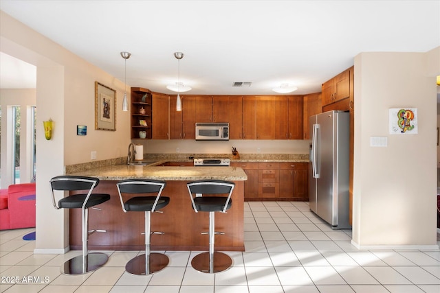 kitchen with visible vents, stainless steel fridge with ice dispenser, decorative light fixtures, a peninsula, and light tile patterned flooring