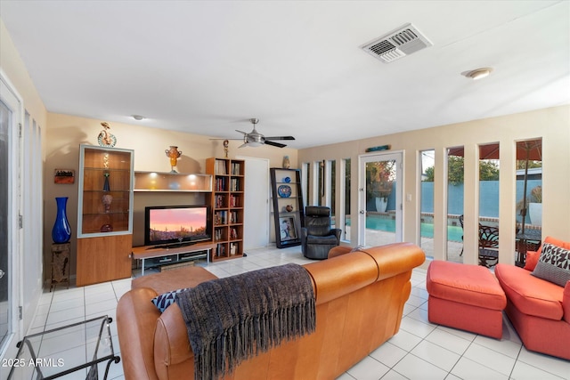 tiled living area with ceiling fan and visible vents