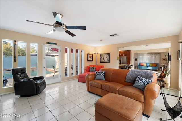 living room featuring visible vents, ceiling fan, and light tile patterned floors