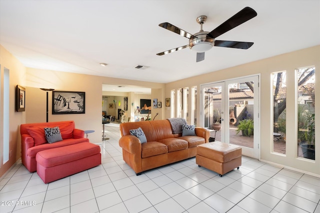 living area with light tile patterned floors, ceiling fan, visible vents, and french doors