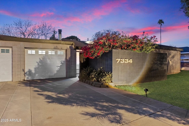 garage at dusk with a detached garage