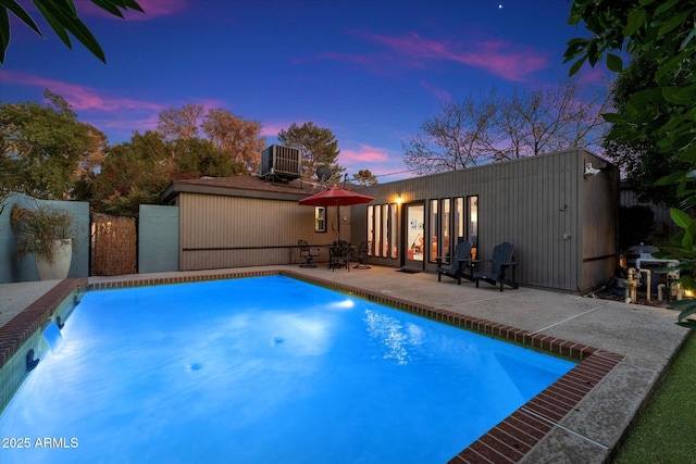 pool featuring central AC unit and a patio