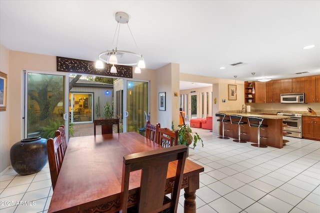 dining space featuring a healthy amount of sunlight, recessed lighting, visible vents, and light tile patterned flooring