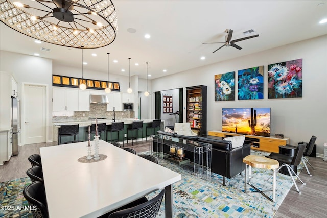 interior space featuring recessed lighting, light wood-style floors, visible vents, and ceiling fan