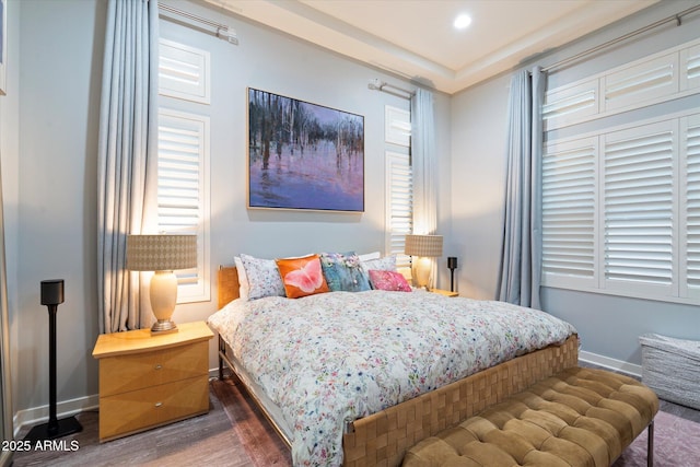 bedroom featuring baseboards, wood finished floors, and recessed lighting