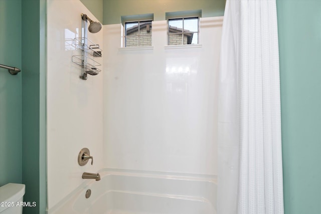 full bathroom featuring shower / tub combo and toilet