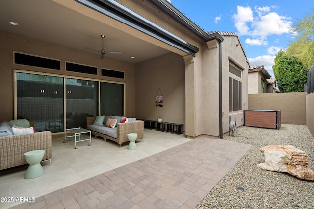 view of patio with a ceiling fan, fence, and an outdoor living space