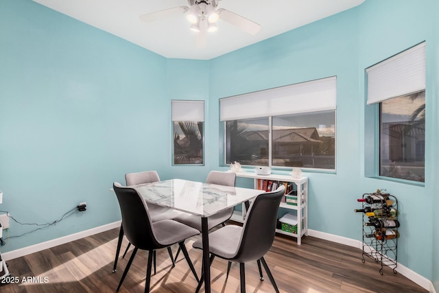 dining space with wood-type flooring and ceiling fan