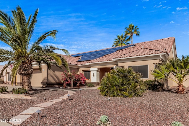 mediterranean / spanish-style house featuring solar panels