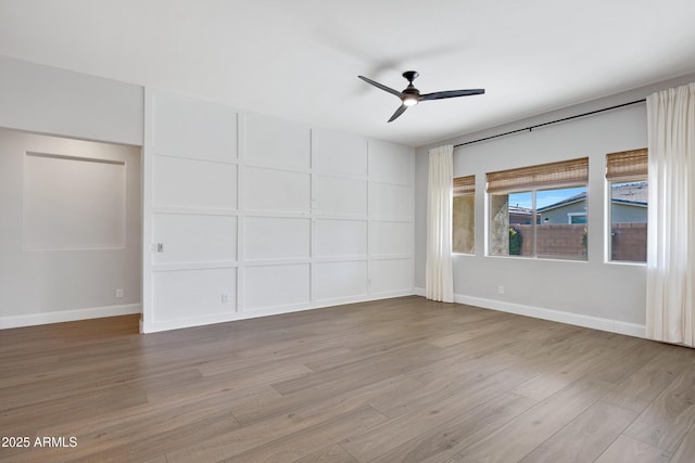 spare room with ceiling fan and light hardwood / wood-style flooring