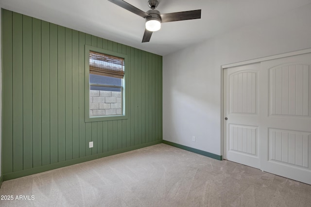 empty room featuring light carpet and ceiling fan