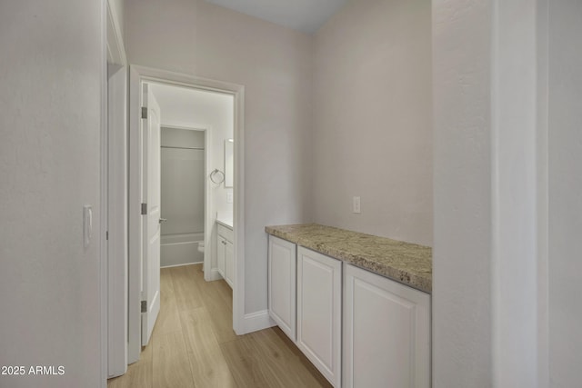 corridor with light hardwood / wood-style floors