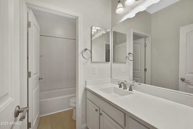 full bathroom with vanity, hardwood / wood-style floors, shower / bathtub combination, and toilet