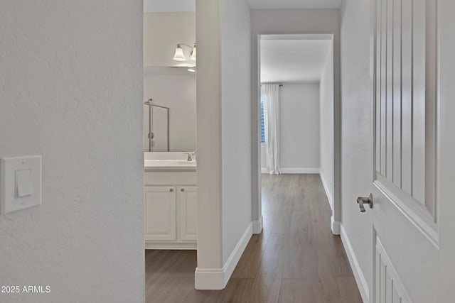 corridor with light hardwood / wood-style floors