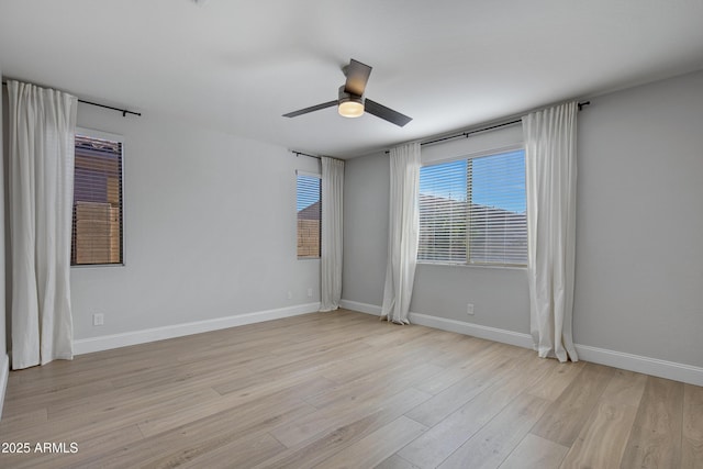 spare room with ceiling fan and light wood-type flooring