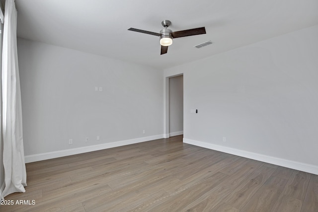 empty room featuring ceiling fan and light hardwood / wood-style flooring