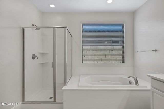 bathroom featuring independent shower and bath and vanity