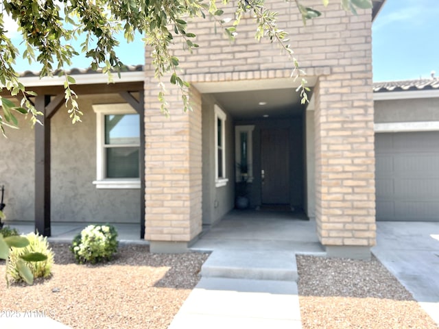 doorway to property with a garage