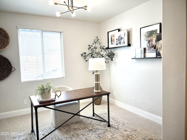 carpeted home office with an inviting chandelier