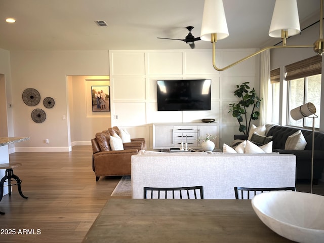 living room featuring hardwood / wood-style flooring and ceiling fan