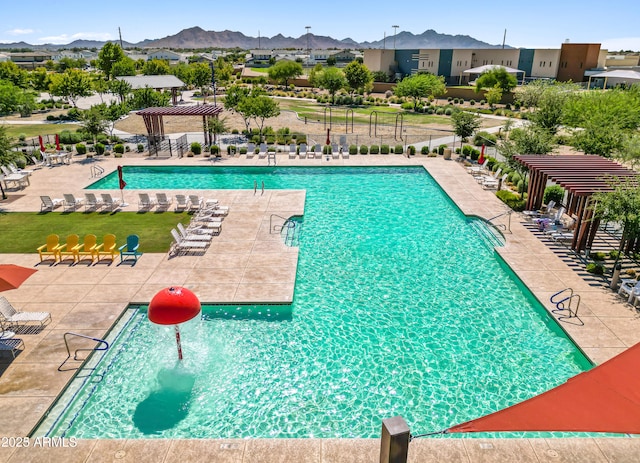 view of swimming pool featuring a patio, a mountain view, and a pergola