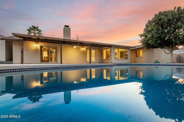 view of pool at dusk