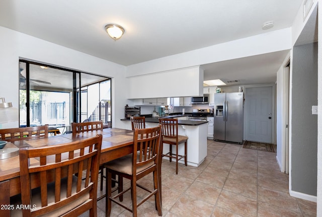 dining space featuring light tile patterned flooring