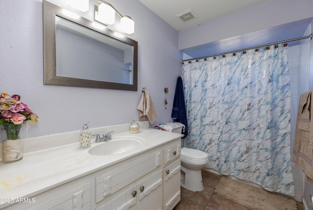 bathroom with vanity, tile patterned floors, and toilet