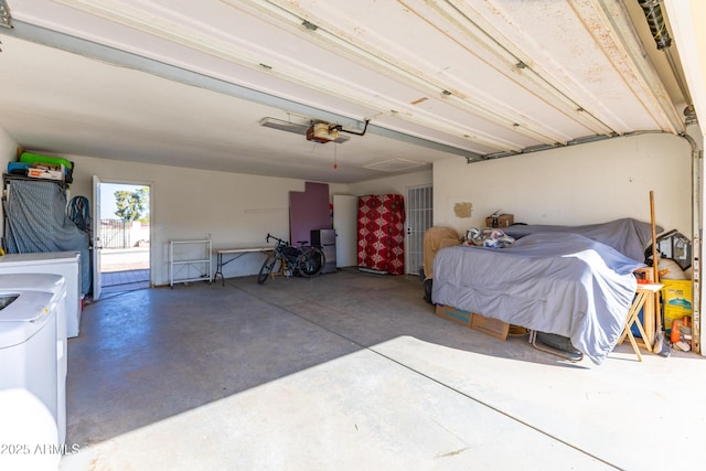 garage featuring washing machine and clothes dryer and a garage door opener