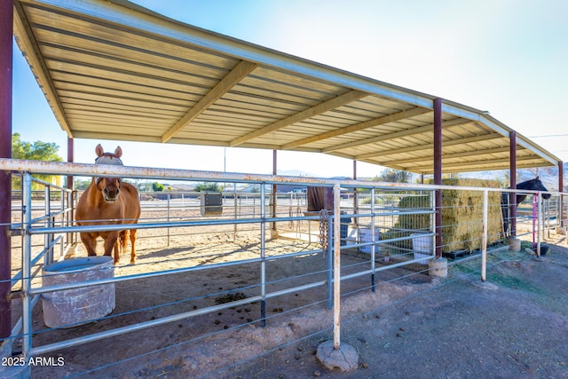 view of horse barn featuring a rural view