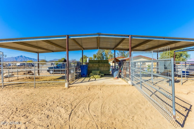 view of horse barn with a mountain view