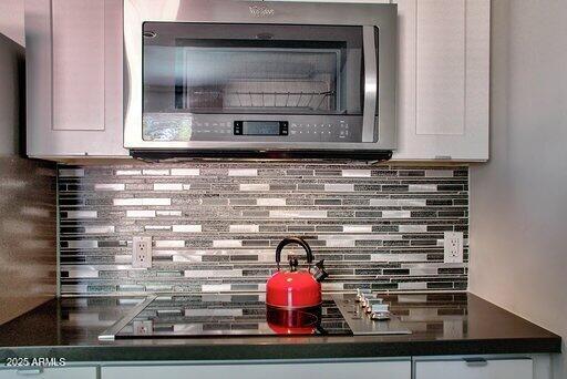 details featuring white cabinetry and decorative backsplash