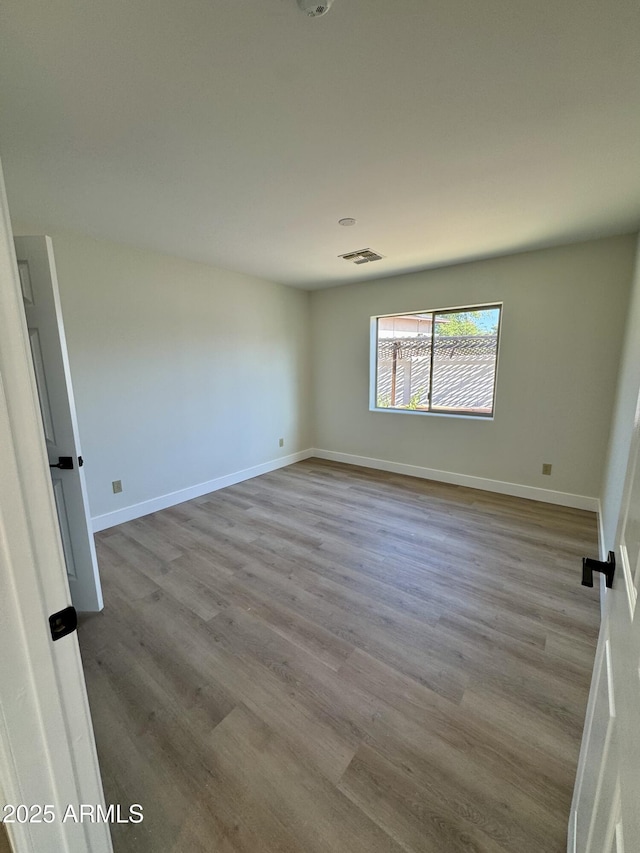 13601 N 50th Pl, Scottsdale, AZ 85254 - spare room featuring wood finished floors and baseboards