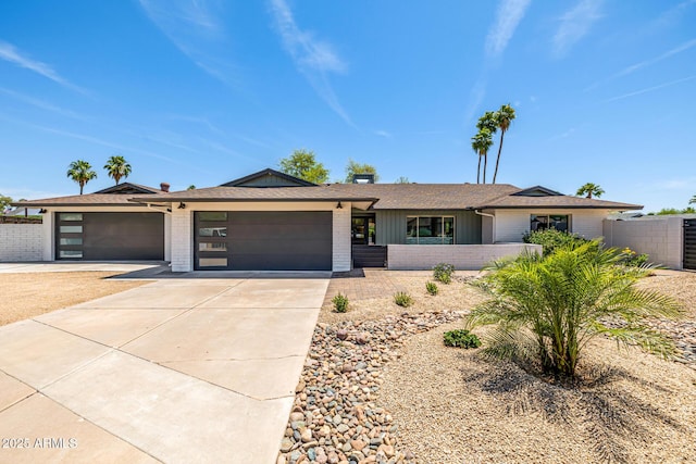 13601 N 50th Pl, Scottsdale, AZ 85254 - ranch-style house featuring brick siding, a garage, driveway, and roof with shingles