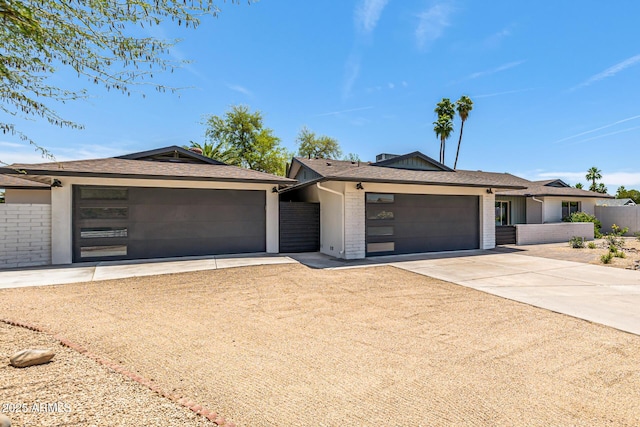13601 N 50th Pl, Scottsdale, AZ 85254 - view of front of house featuring concrete driveway, an attached garage, brick siding, and roof with shingles