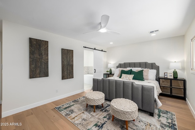13601 N 50th Pl, Scottsdale, AZ 85254 - bedroom featuring a barn door, wood finished floors, baseboards, recessed lighting, and a ceiling fan