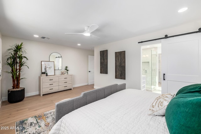 13601 N 50th Pl, Scottsdale, AZ 85254 - bedroom with light wood finished floors, baseboards, recessed lighting, a barn door, and ceiling fan