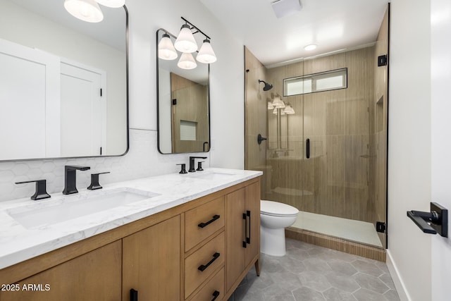 13601 N 50th Pl, Scottsdale, AZ 85254 - bathroom featuring a shower stall, toilet, double vanity, and tasteful backsplash