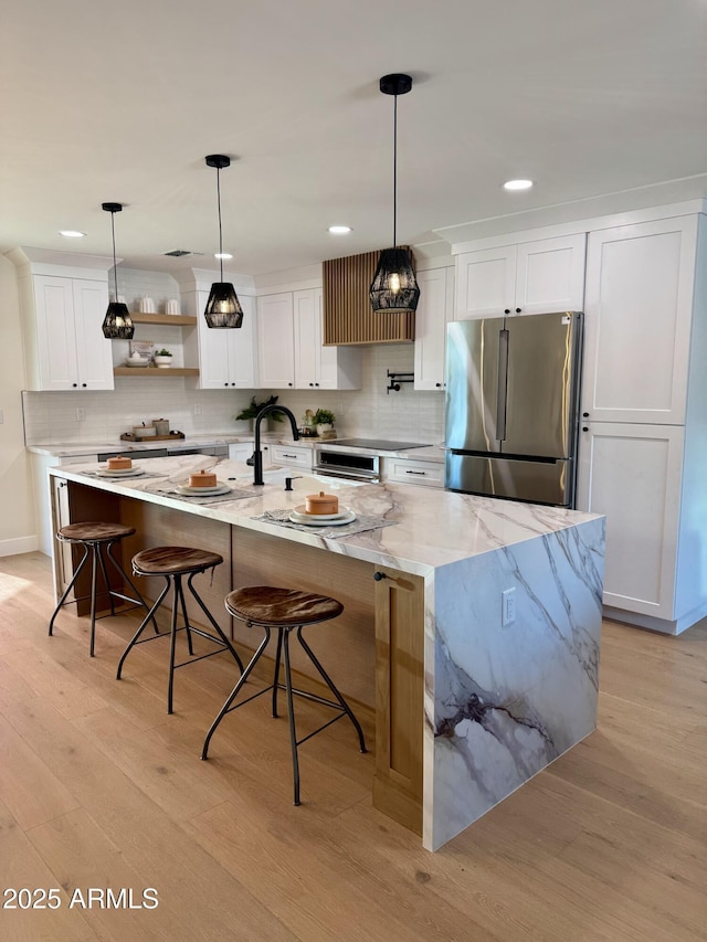13601 N 50th Pl, Scottsdale, AZ 85254 - kitchen with freestanding refrigerator, light wood-style floors, white cabinetry, decorative backsplash, and recessed lighting