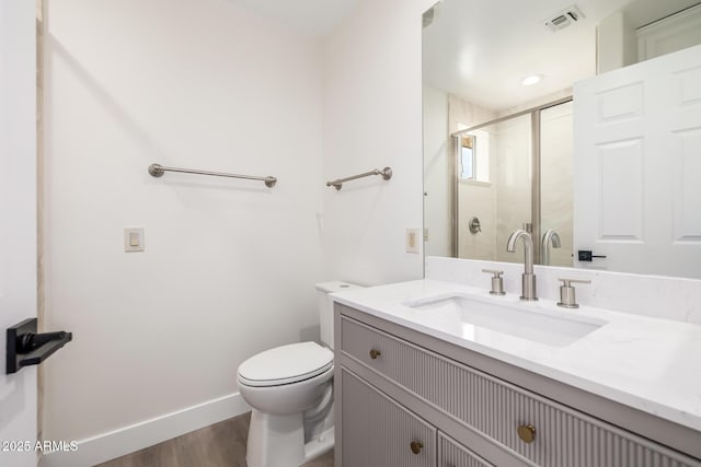 13601 N 50th Pl, Scottsdale, AZ 85254 - bathroom with toilet, vanity, wood finished floors, a stall shower, and baseboards