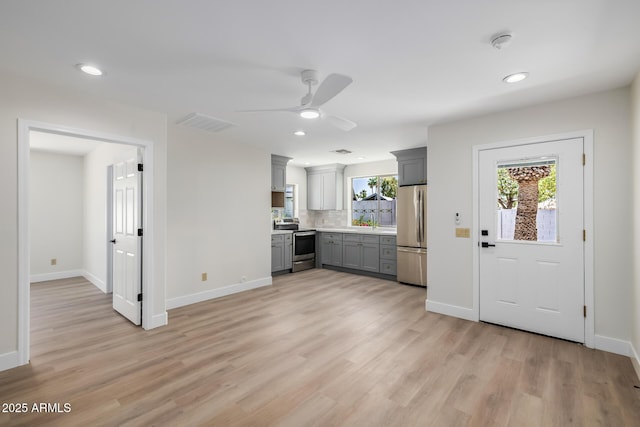 13601 N 50th Pl, Scottsdale, AZ 85254 - kitchen with appliances with stainless steel finishes, gray cabinets, light wood-style flooring, ceiling fan, and baseboards