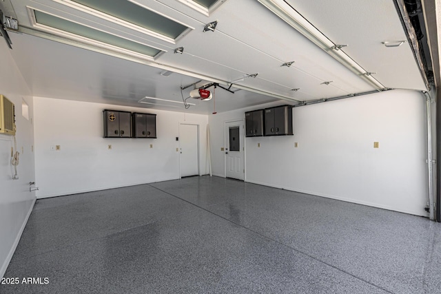 13601 N 50th Pl, Scottsdale, AZ 85254 - garage featuring a garage door opener, electric panel, and baseboards
