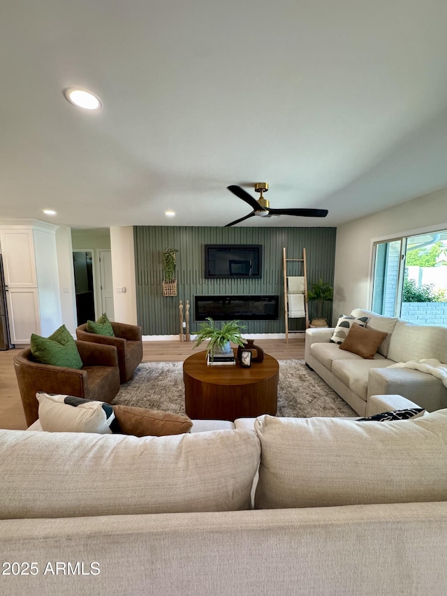 13601 N 50th Pl, Scottsdale, AZ 85254 - living area with wood finished floors, a ceiling fan, recessed lighting, and a glass covered fireplace