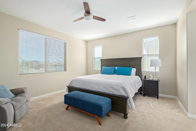 bedroom with ceiling fan and light carpet