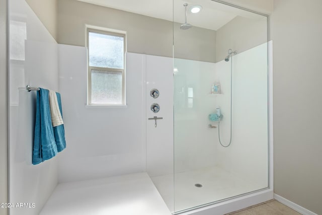 bathroom featuring walk in shower and tile patterned flooring