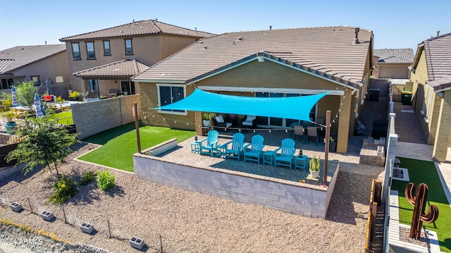 back of property with a patio